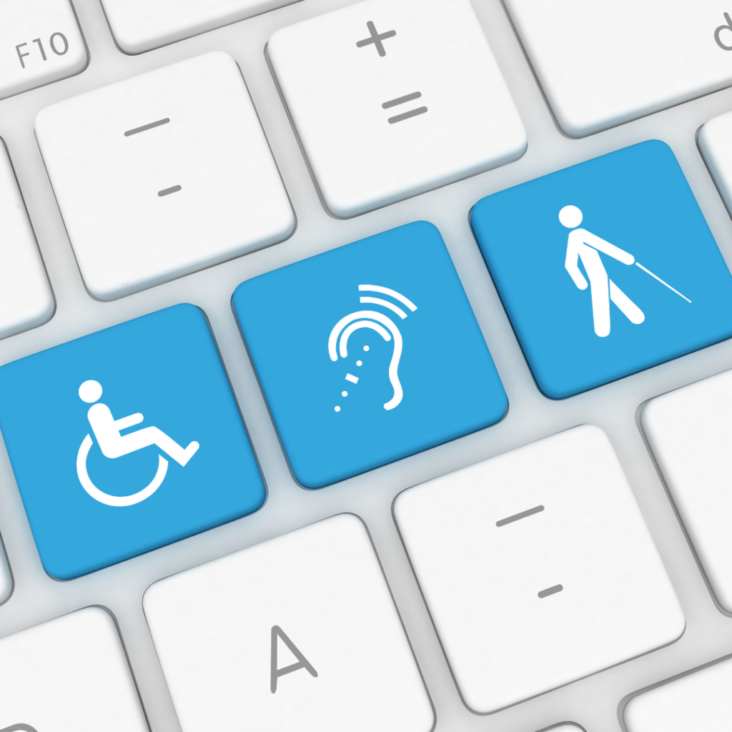 A closeup of a keyboard with a wheelchair button, a hearing aid button, and a Blind person on a button